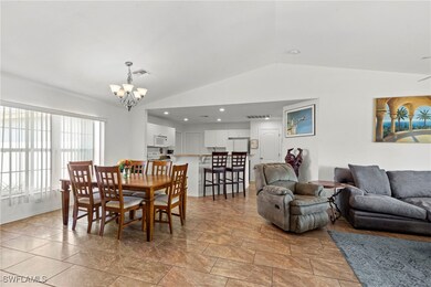 Dining room with vaulted ceiling, a chandelier, st