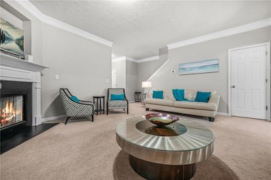 Living room featuring carpet, ornamental molding, 
