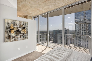 Unfurnished bedroom featuring floor to ceiling windows, carpet flooring, a city view, and access to exterior