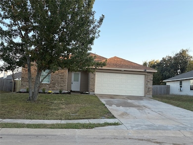View of front of house featuring brick siding, driveway, an attached garage, and a shingled roof