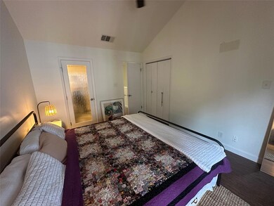 Bedroom with baseboards, wood finished floors, lo