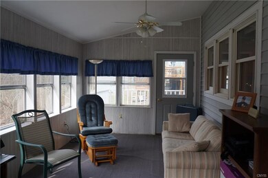 Enclosed porch off kitchen leads to deck