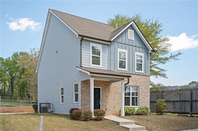 View of front facade with brick siding, board and batten siding, cooling unit, and a shingled roof