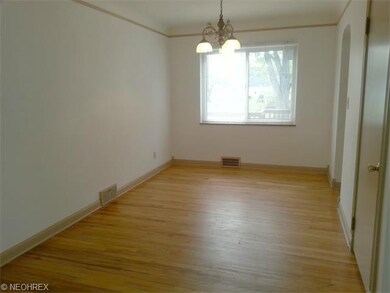 Spacious dining room with fresh paint and hardwood