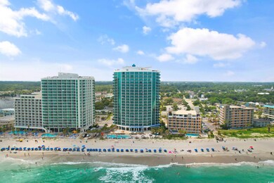 Birds eye view of property with a water view and a