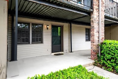 Property entrance with a porch and a balcony