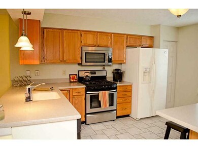 Kitchen. Honey cabinets and light solid surface co