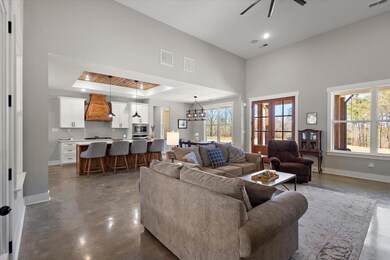 Living room featuring concrete floors, visible ven