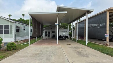 View of vehicle parking featuring concrete driveway and an attached carport