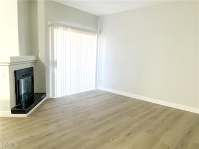 Unfurnished living room featuring wood finished fl