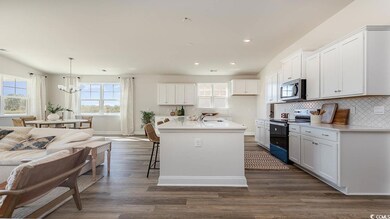 Kitchen featuring white cabinets, black electric r