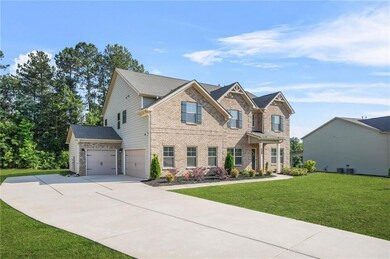 Craftsman house with brick siding, driveway, and a front yard
