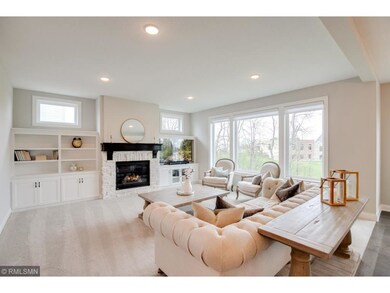 Main level living room features a stone gas firepl