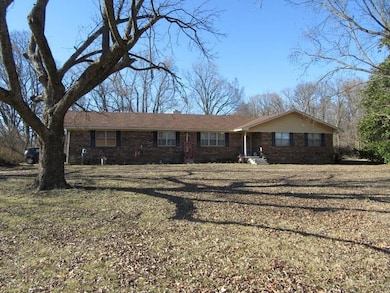 Ranch-style house featuring a front lawn and brick