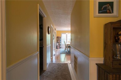 View from top of the stairway looking down the hallway to the kitchen.