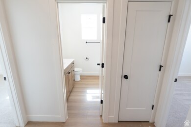 Hallway featuring baseboards and light wood finished floors