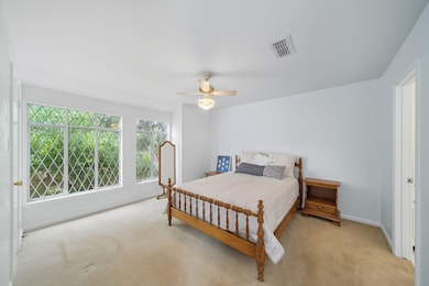 Upstairs are two large bedrooms this one looks over the lush courtyard and has a closet with a window too!