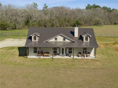 Back of house featuring a yard, metal roof, french