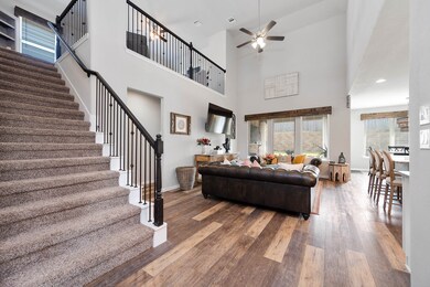 Walking into this gorgeous home you get a feel of just how grand everything is, this space showcases soaring high ceilings, fluid floor plan, custom paint for a cooling feel, stunning second floor balcony overlooking the living room and entryway with custom iron railing details, crown molding and gorgeous wood like floors throughout! This home is breathtaking.