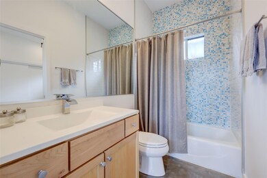Bathroom featuring toilet, shower / tub combo, an