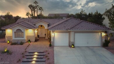 FRONT VIEW OF PROPERTY AT SUNSET FEATURING LIGHTED