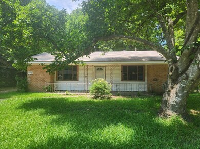 Ranch-style home featuring a front lawn