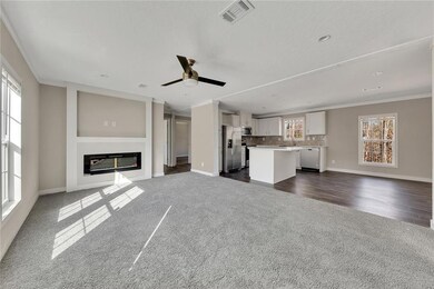 Unfurnished living room featuring ornamental moldi