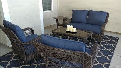 Screened porch large and cozy with ceiling fan