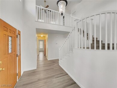 Entrance foyer with a high ceiling, wood finished