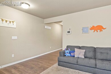 Living area with wood finished floors and baseboards