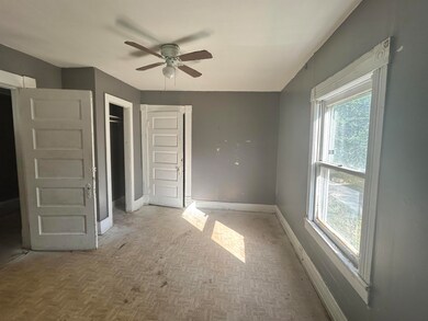 Unfurnished bedroom with baseboards and ceiling fan