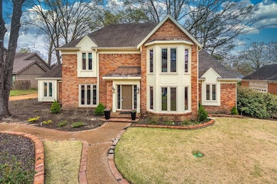 View of front of house with brick siding, a shingl