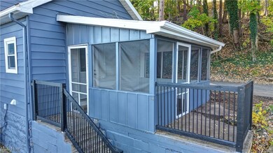 View of home's exterior with a sunroom and board and batten siding