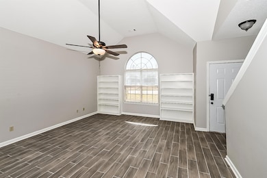 Interior space with a ceiling fan, dark wood-style