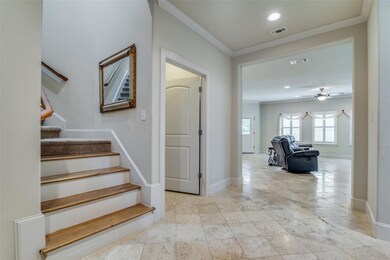 Foyer with view of staircase. Ornamental molding, gorgeous floors, bright and light