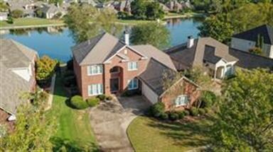 Aerial view of the home showing pond and fountain.