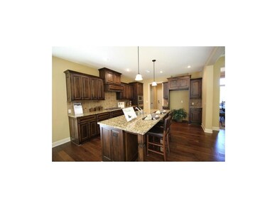 Kitchen with Stained Cabinets and Granite Counters