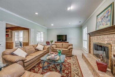 Large living room with raised wood-burning fire pl