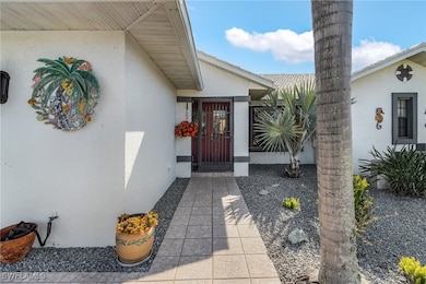 Doorway to property featuring stucco siding