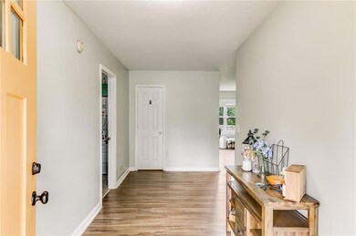 Corridor featuring light wood-style flooring and baseboards