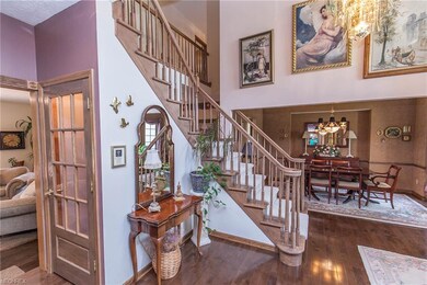 2 Story Foyer with dual staircase and hardwood flooring