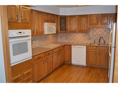 Beautiful oak cabinets, white GE appliances, grani