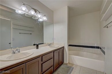 Full bathroom with tile patterned floors, double v