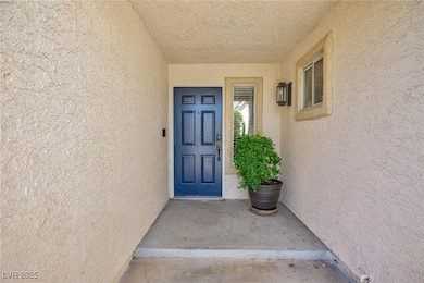 View of exterior entry with stucco siding