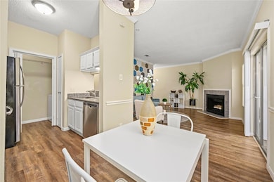Dining room with dark wood-style floors, a tile f