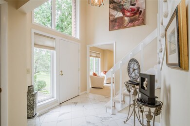 Your guests are greeted by a vaulted open foyer -