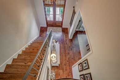 Hardwood floors continue up the grand staircase
