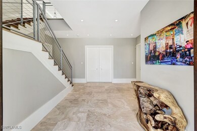 Foyer entrance featuring stairs, recessed lighting