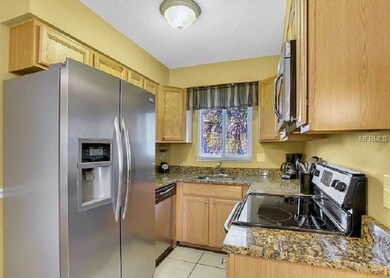 Updated kitchen with wood cabinets, stainless appl