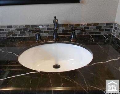 Secondary bath with custom tile backsplash